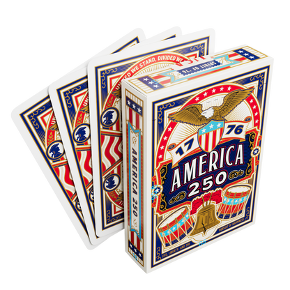 Remembrance America 250 playing card tuck box displayed with several cards showing the patriotic card back design.